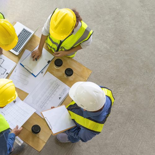 engineering teamwork meeting on site work,engineers project manager consultation meeting with coworker.concept of engineering or architecture working outdoors for a new real estate home project